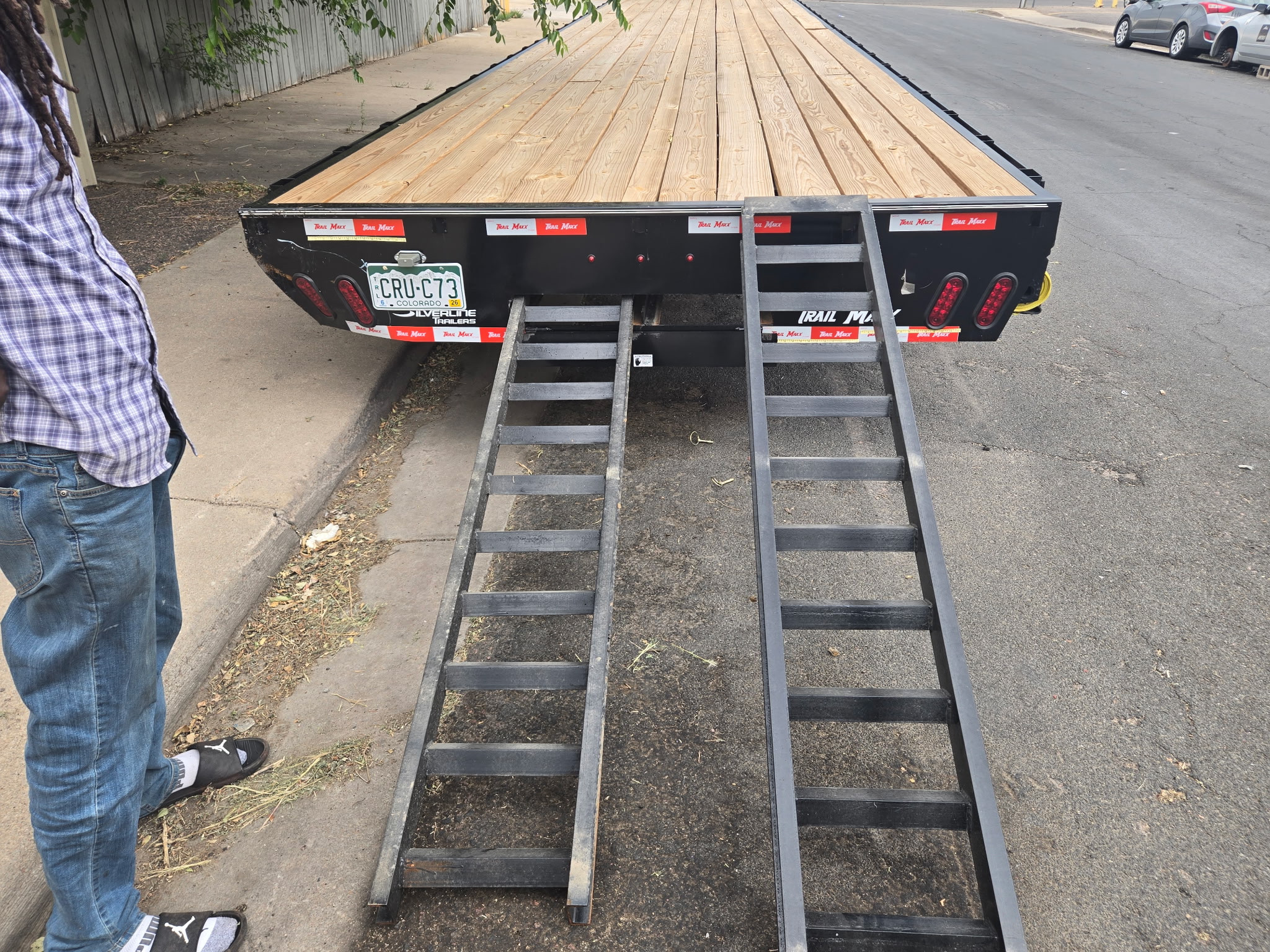 Crew loading ramps on the hauling trailer